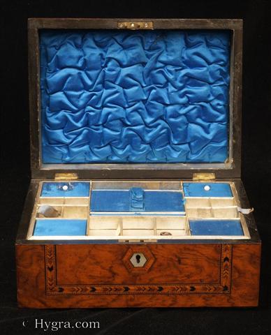 Antique inlaid figured walnut box with domed top opening to a ruched satin lined lid and a compartmentalized lift-out tray  fitted for sewing with supplementary lids Circa 1870. -Enlarge Picture